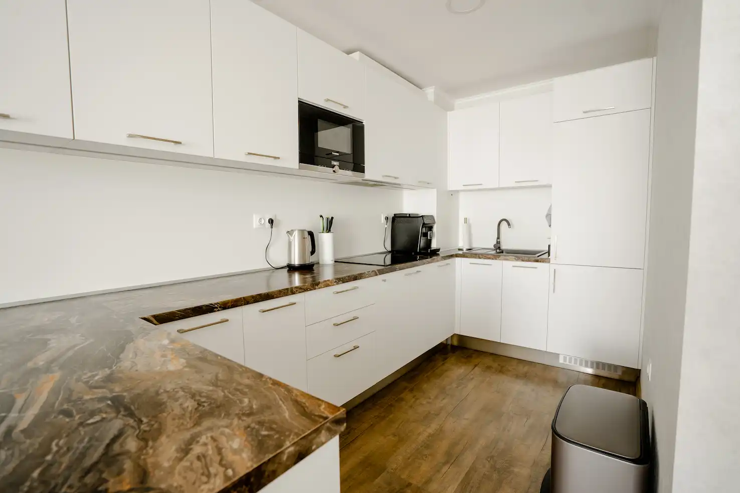 Modern kitchen with white cabinets and granite countertops